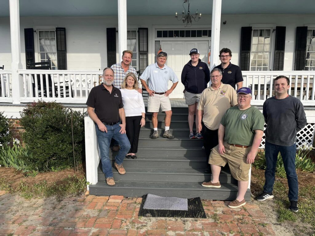 Wade Sokolosky in center of group photo of members of Civil War medical history groups on steps of Oak Grove Plantation