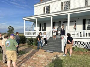 Wade Sokolosky speaking from the steps of Oak Grove Plantation house